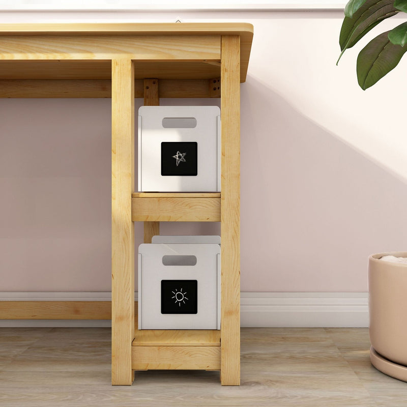 Wooden desk shelving with white storage bins featuring black icon labels, pale pink wall and potted plant for home office organization