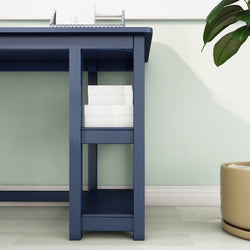 Modern blue desk with white books and plant, stylish home office furniture.
