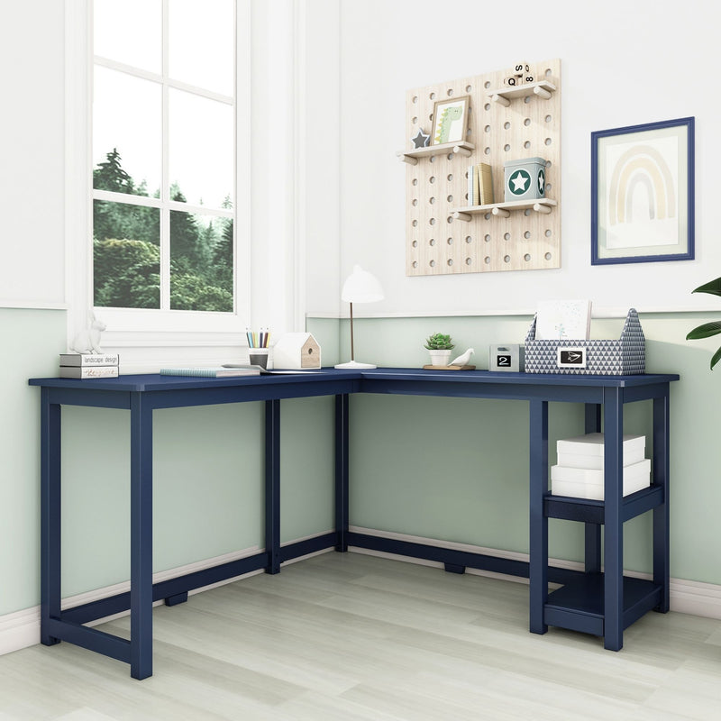 Modern kids' study corner with navy L-shaped desk, pegboard wall shelves, pastel decor and large window with greenery