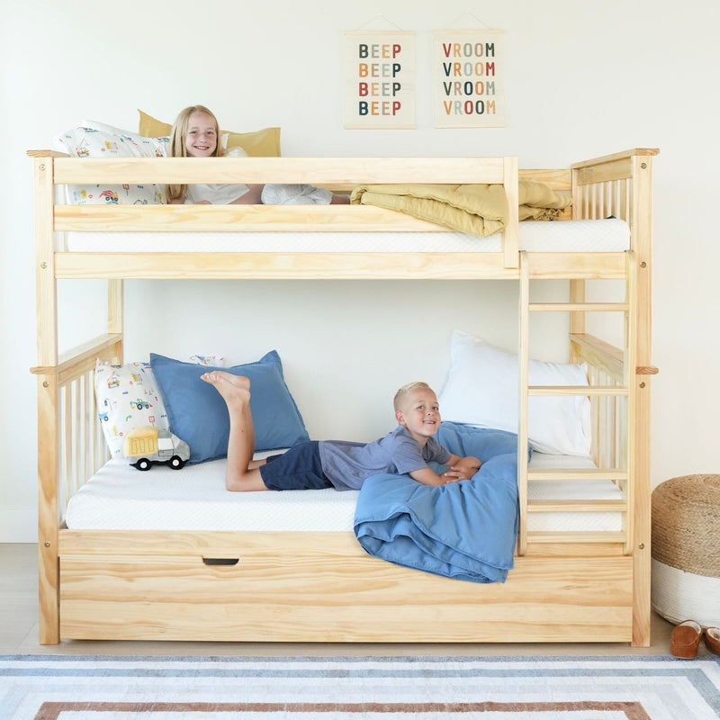 Two smiling children on a natural pine wooden bunk bed with ladder, blue bedding, under-bed storage drawer, toy truck and playful wall art in a bright kids' bedroom