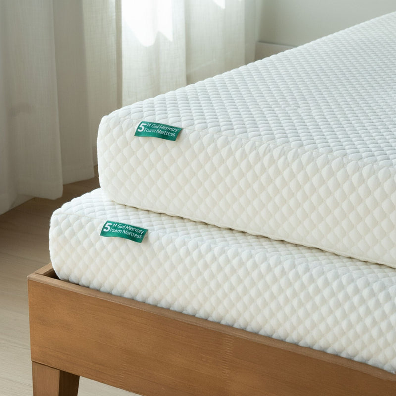 Stacked white 5-inch gel memory foam mattresses with quilted cover on a wooden bed frame in a bright minimalist bedroom