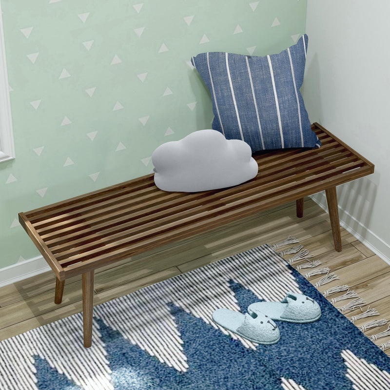 Stylish wooden bench with striped and cloud-shaped cushions, accompanied by cozy bedroom decor in modern interior design.
