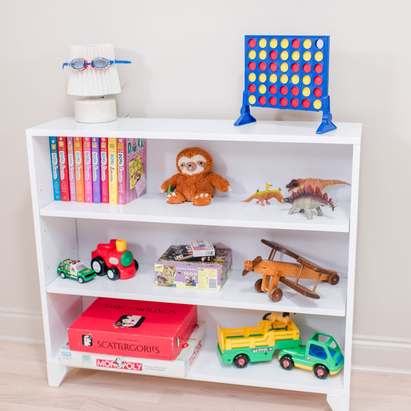 Children's bookshelf with toys, books, board games, and a Connect Four game.