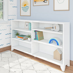 White bookshelf with decorative items and books in a modern blue-themed children's room.