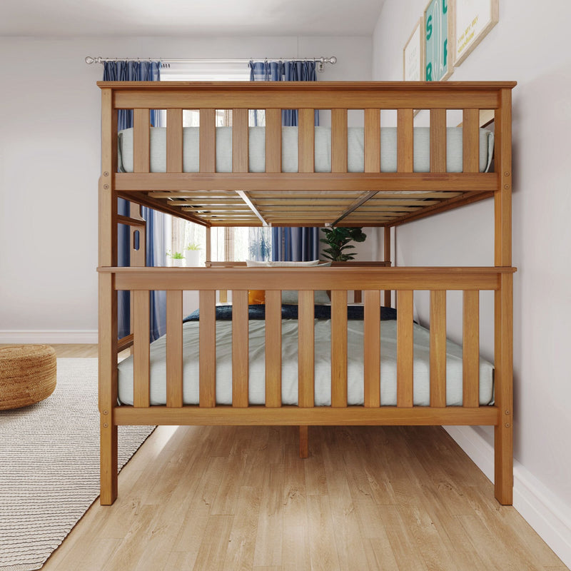 Solid wood twin-over-full bunk bed in natural finish in bright children's bedroom with blue curtains, hardwood floor and slatted guard rails