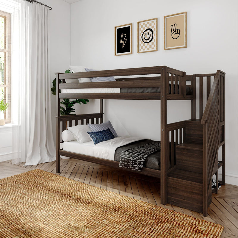 Modern kids' bedroom featuring a dark wood bunk bed with staircase, cozy lower bed with patterned pillows, neutral wall art, white curtains and natural hardwood floor.