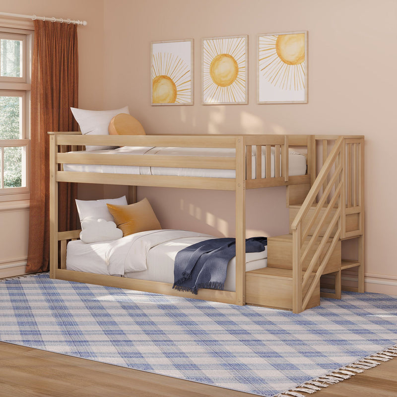 Wooden bunk bed with staircase in a peach kids' bedroom — neutral boho nursery decor with sun wall art, rust curtains, plush pillows and blue plaid area rug under natural window light
