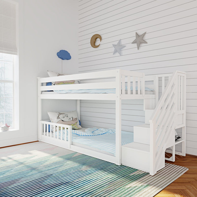 White wooden bunk bed with stairs in a coastal-style kids bedroom, blue striped bedding and rug, shiplap wall with moon, star and cloud wall decor.