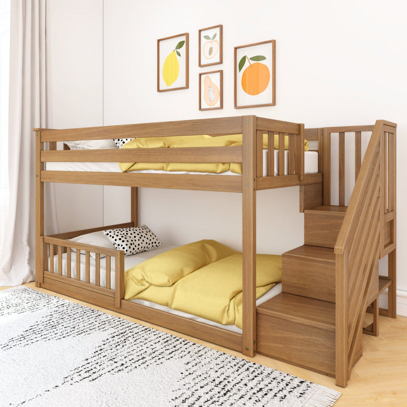 Modern natural wood bunk bed with built-in stairs and yellow bedding in a space-saving kids' room nursery with framed fruit wall art