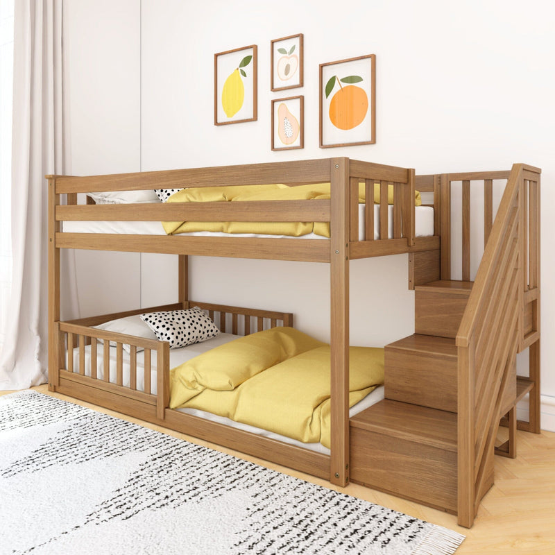 Solid wood bunk bed with staircase in children's bedroom, yellow bedding, polka-dot pillows and fruit wall art