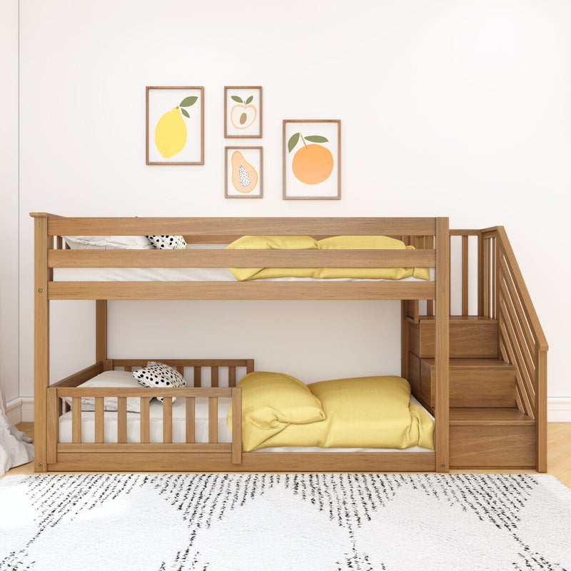 Natural wood bunk bed with stair storage and yellow bedding in a minimalist kids' bedroom with fruit-themed framed wall art on a white wall — nursery decor, children's bedroom design