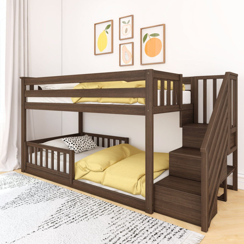 Dark wood twin-over-twin bunk bed with stairs and built-in storage, yellow bedding and polka-dot pillow, fruit wall art in a bright kids' bedroom
