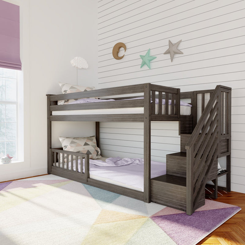 Dark wood loft bunk bed with stairs in bright children's bedroom with white shiplap wall, pastel star-and-moon wall decor, purple bedding and window shade