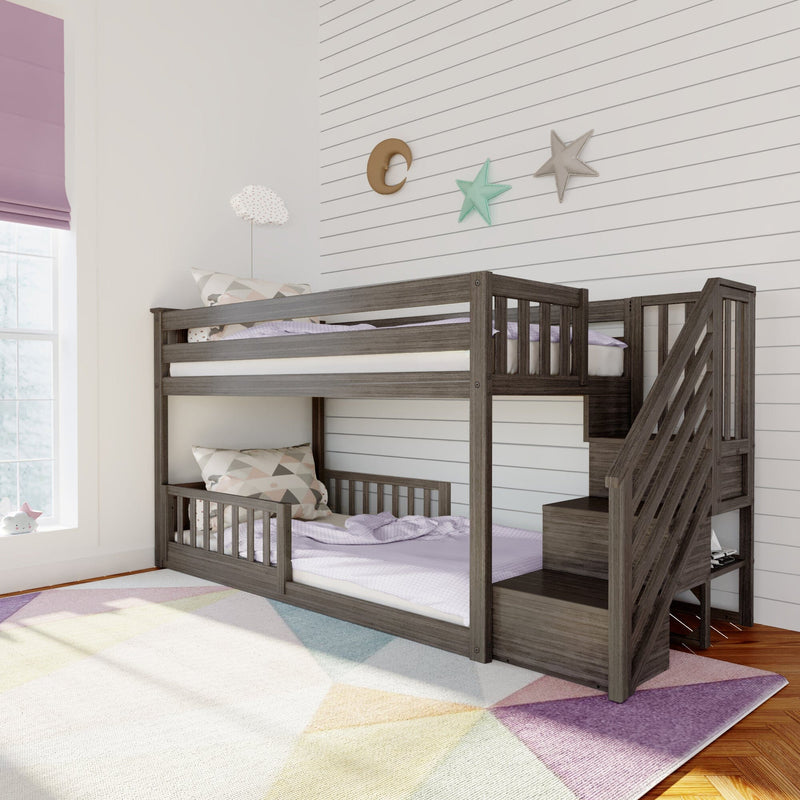 Dark wood twin-over-twin bunk bed with stairs and storage in children's bedroom, pastel bedding, shiplap accent wall, star and moon wall decor, lavender Roman shade and colorful geometric rug