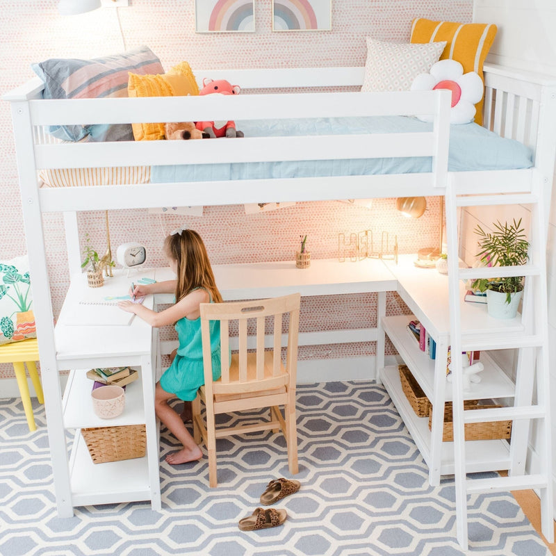 White kids loft bed with built-in desk and shelving in a pastel bedroom, child drawing at the study desk, colorful pillows, plush toys and potted plant — compact workspace and storage for children's room