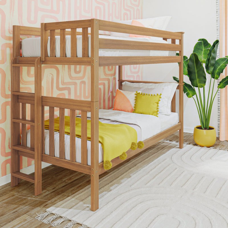 Modern natural wood bunk bed in kids' bedroom with yellow throw blanket, colorful pillows, pink abstract wallpaper and potted tropical plant