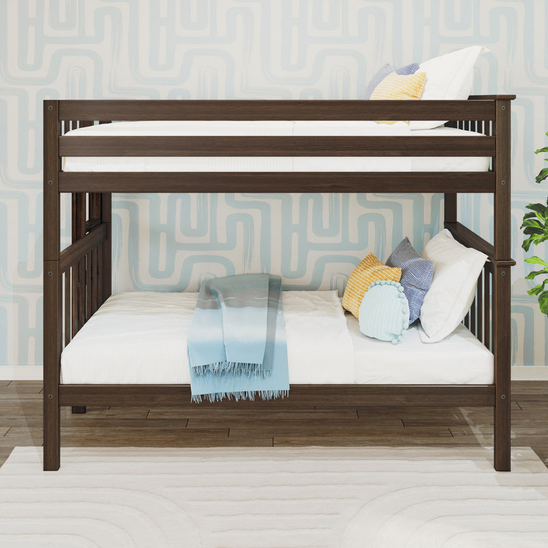 Dark wood twin-over-twin bunk bed with white bedding, blue gradient throw and decorative pillows against light blue geometric wallpaper in a children's bedroom