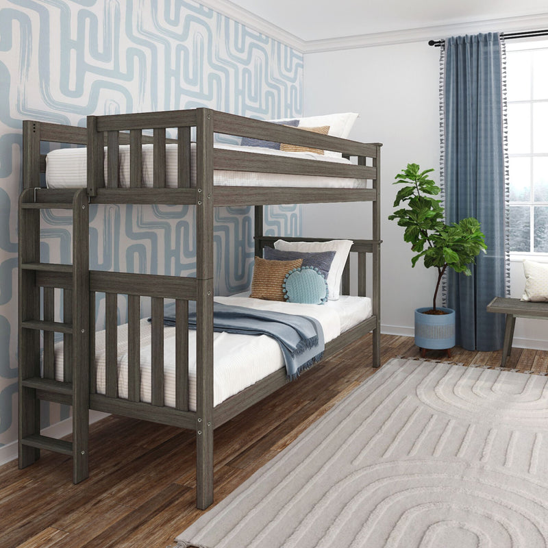 Gray wooden twin-over-twin bunk bed in modern kids' bedroom with blue geometric wallpaper, hardwood floors, textured rug, curtains and potted plant