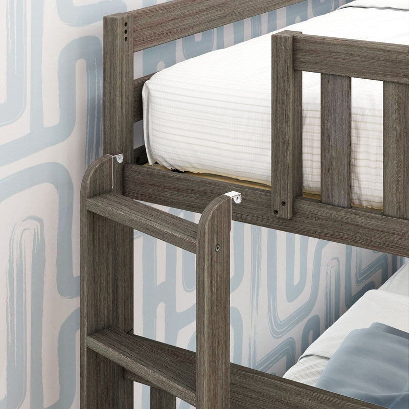 Gray-washed wooden bunk bed close-up with ladder and safety rails, white striped bedding and blue geometric wallpaper in a modern kids' bedroom
