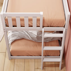 White wooden bunk bed with peach-colored sheets and a ladder, perfect for a cozy bedroom setup.