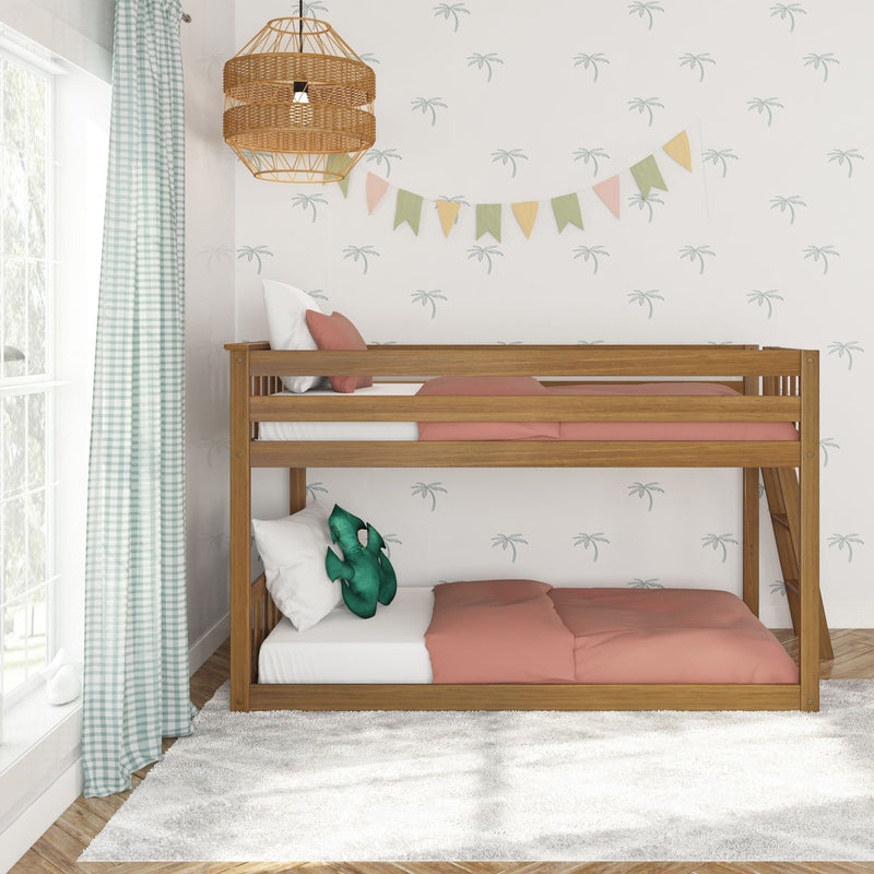 Wooden kids bunk bed with coral bedding, palm-print wallpaper, pastel bunting flags, gingham curtains, plush dinosaur pillow and rattan pendant light