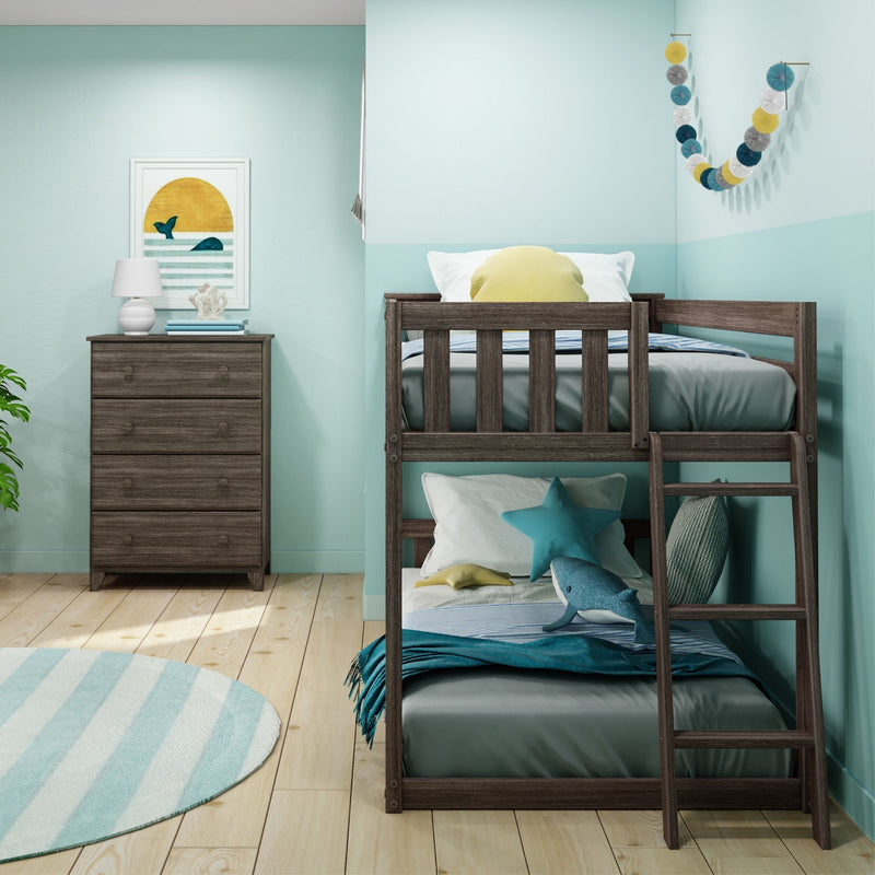 Kids coastal bedroom with wooden bunk bed and ladder, teal walls, star pillow and shark plush, striped rug, wooden dresser, lamp and beach whale wall art