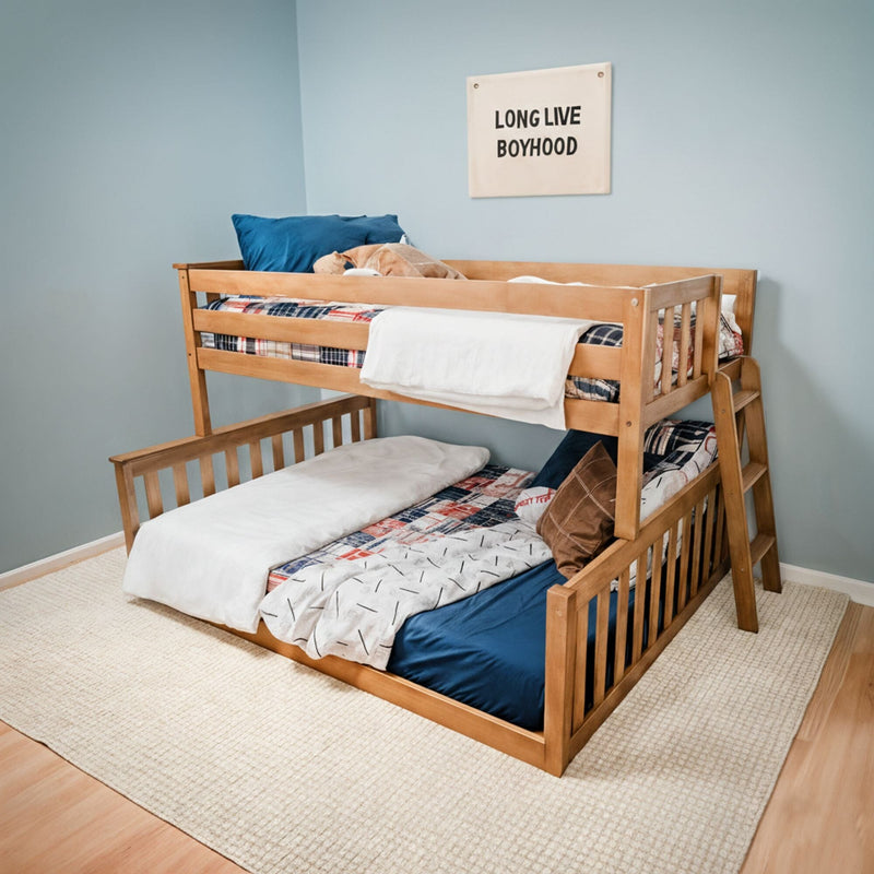Twin-over-twin wooden bunk bed in boys' bedroom with plaid bedding, blue pillow, "Long Live Boyhood" wall sign and neutral area rug
