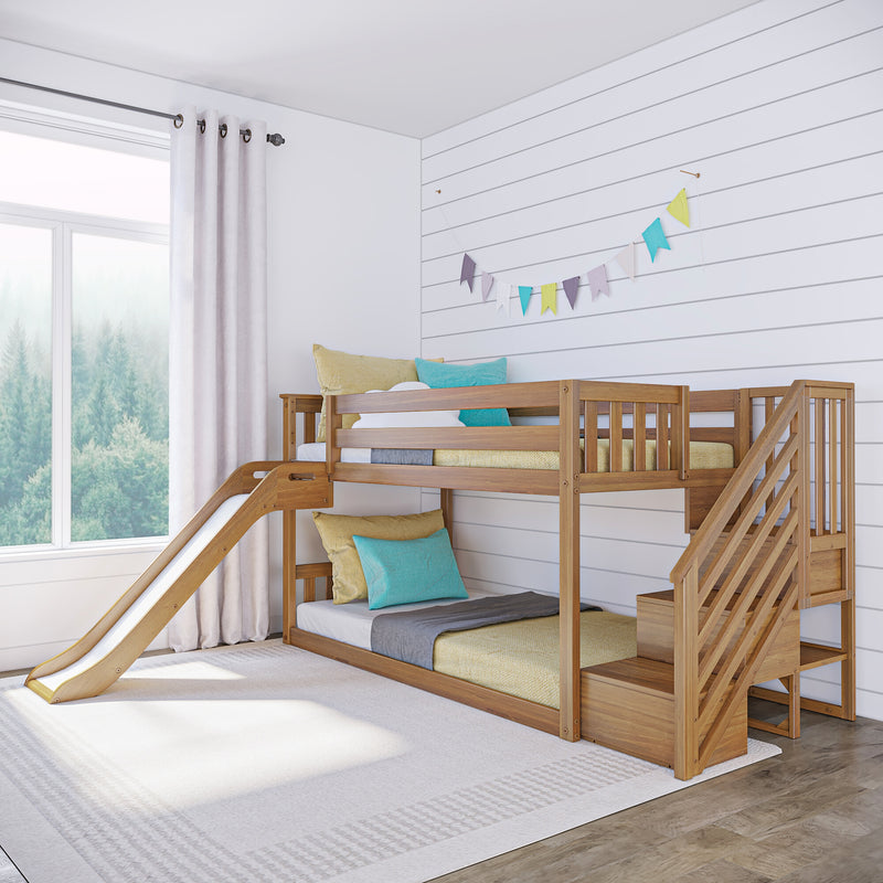 Bright modern kids' bedroom with wooden bunk bed and slide, white shiplap wall, colorful pennant bunting, teal and yellow pillows, and large window with forest view