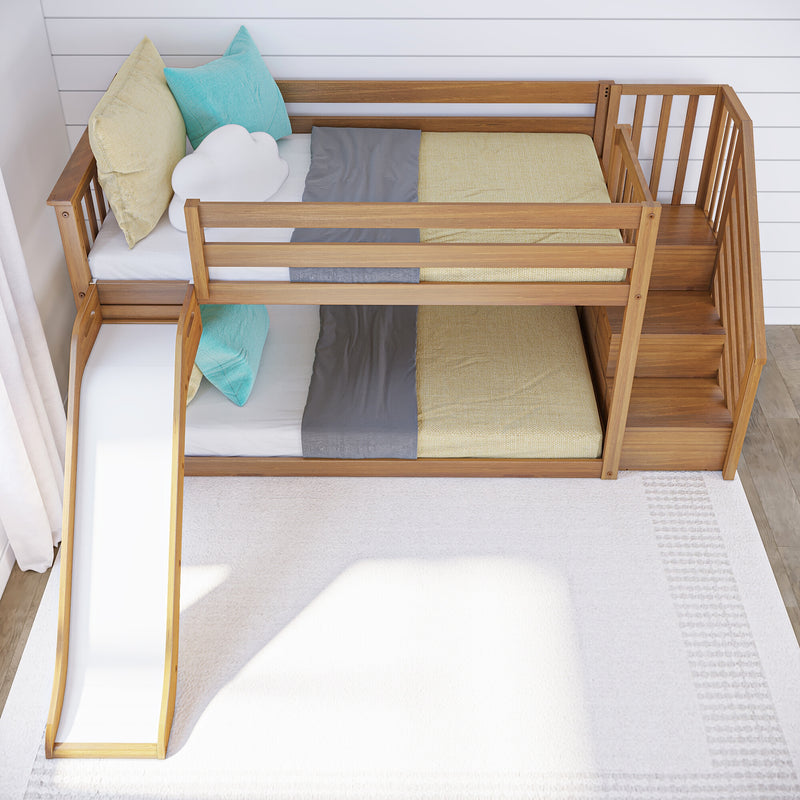 Modern wooden kids loft bed with slide and staircase, beige and gray bedding, teal and yellow pillows in bright nursery