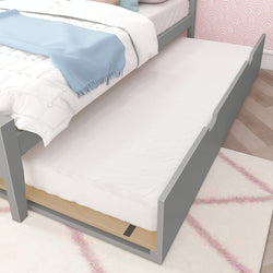 Gray trundle bed with white bedding in a modern bedroom setting.