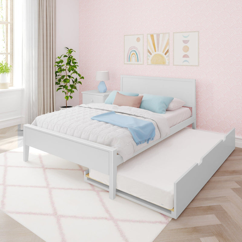 Pastel pink kids' bedroom with white trundle bed, blue and pink pillows, scalloped wallpaper, rainbow and sun wall art, bedside lamp and potted plant