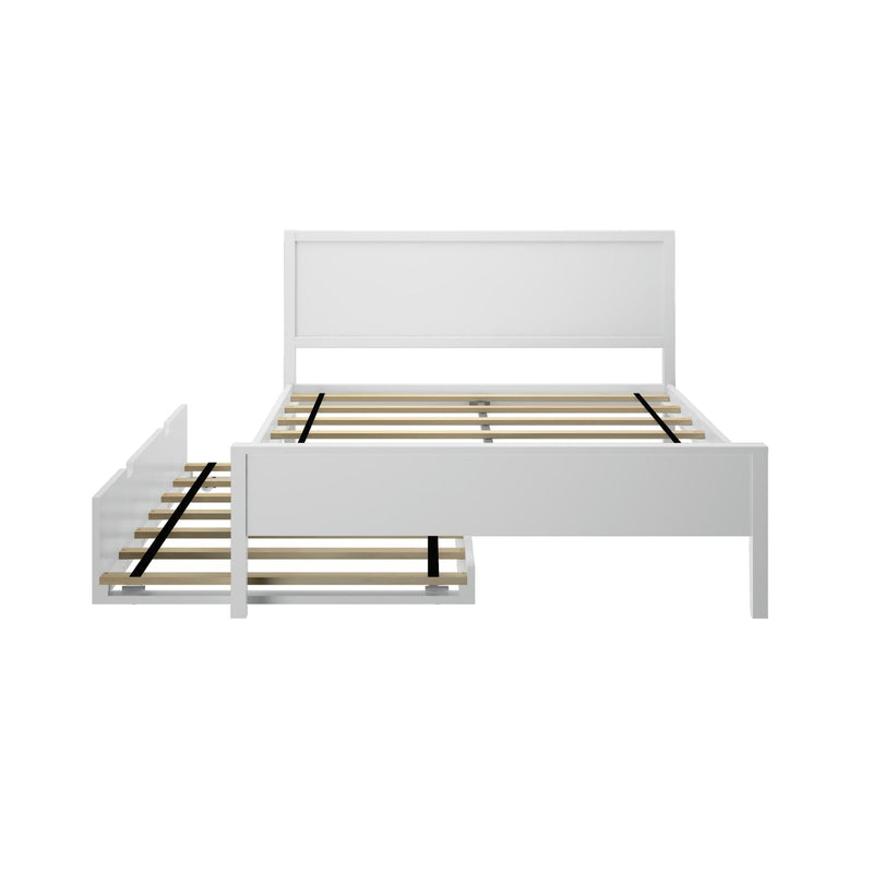 Modern white wooden platform bed frame with headboard, exposed wooden slat mattress support, black center support straps and pull-out trundle drawer on white background