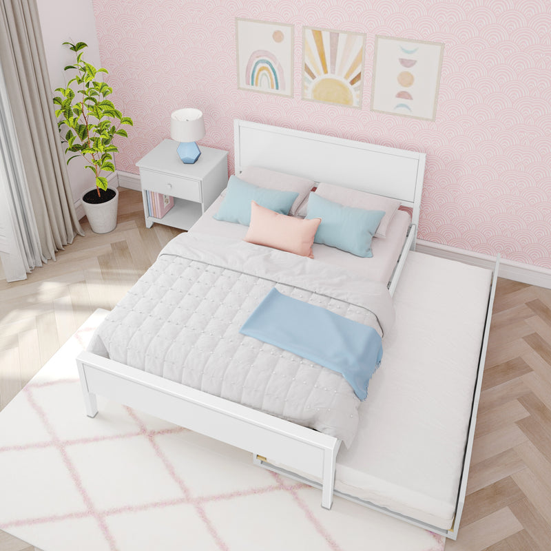 Pastel pink kids bedroom with white twin bed and pull-out trundle, scallop-pattern wallpaper, pastel blue and blush pillows, white nightstand with lamp and potted plant, rainbow and sun wall art