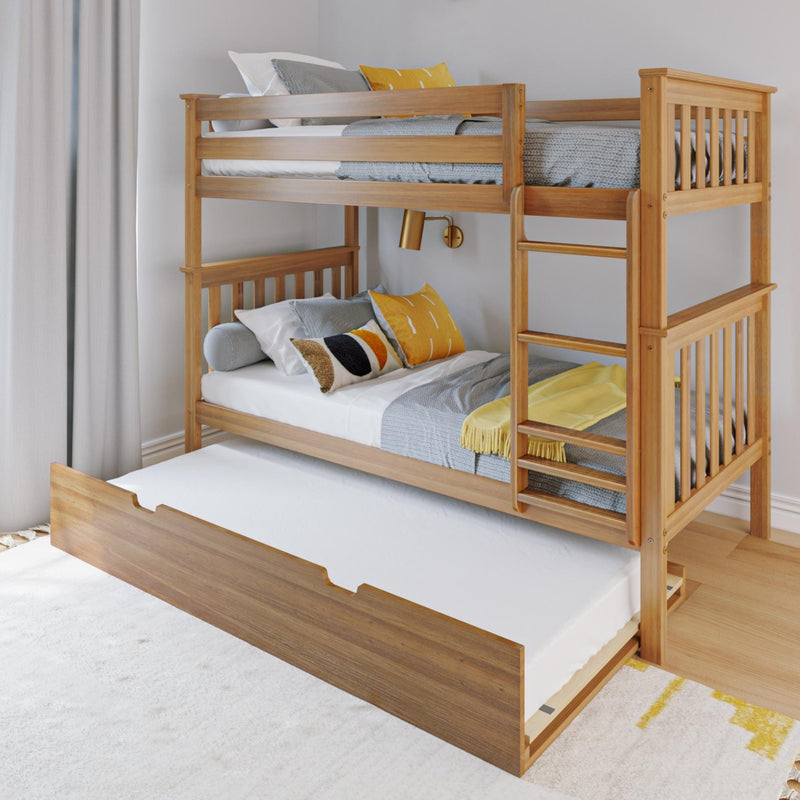 Solid wood bunk bed with pull-out trundle and ladder, styled with grey knit blankets and yellow accent pillows in a modern, space-saving kids' bedroom