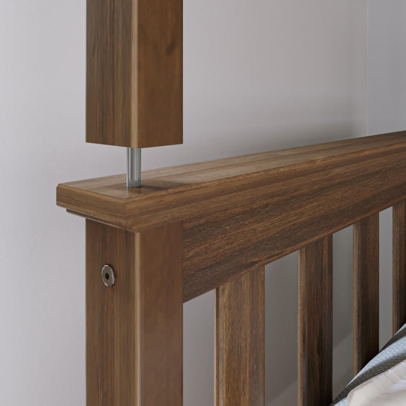 Close-up of walnut slatted wooden bed headboard with modern metal-post bedside lamp — bedroom furniture