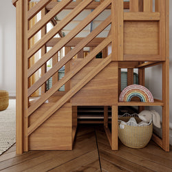 Wooden staircase with built-in storage shelves, featuring a colorful rainbow toy and a wicker basket with a plush bunny toy.