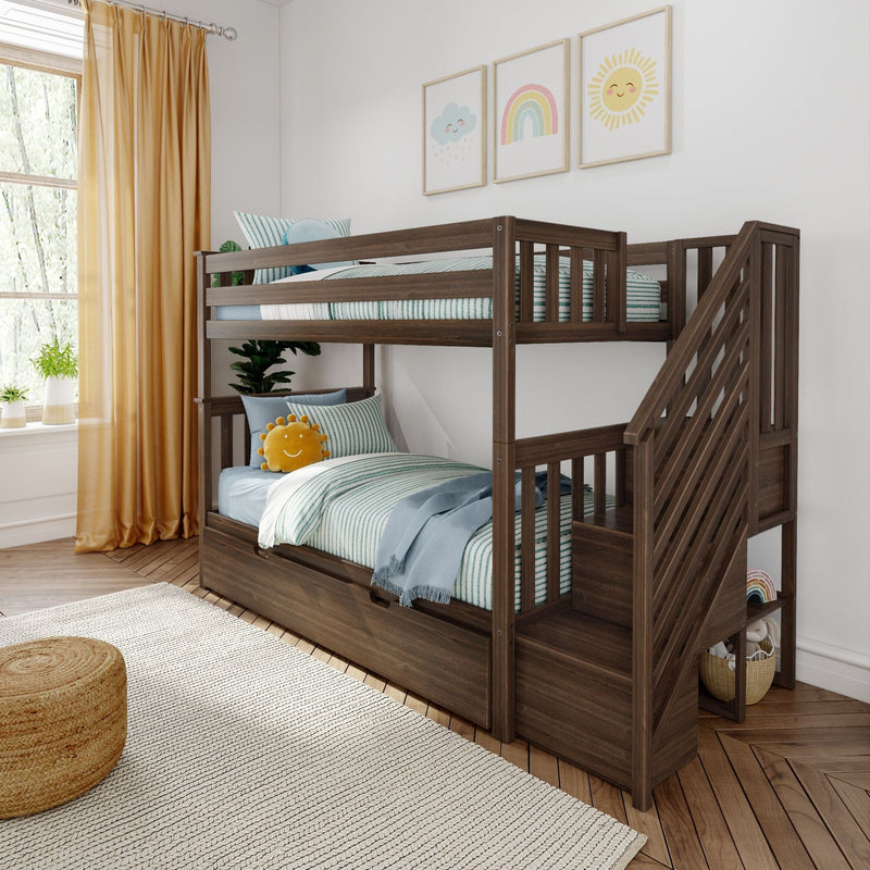 Dark wood twin-over-twin bunk bed in a bright kids’ bedroom with green-striped bedding, pastel sun and rainbow wall art, yellow curtains and under-bed storage