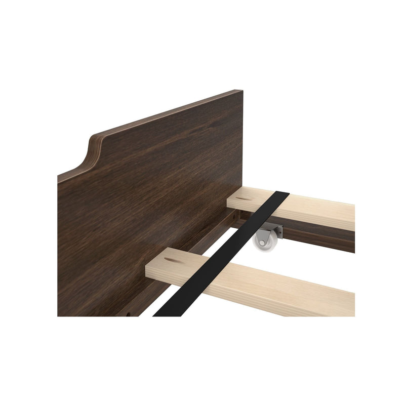 Wooden bed frame corner with dark stained headboard and reinforced slats.