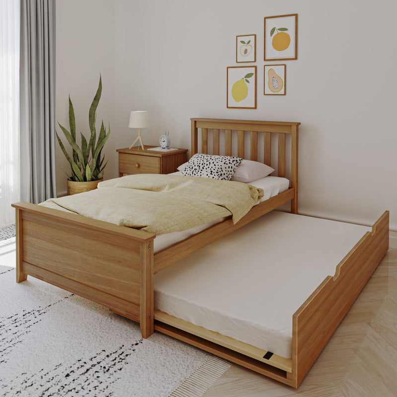 Natural oak single bed with pull-out trundle mattress in bright minimalist bedroom, yellow duvet, wooden nightstand, potted plant and fruit wall art