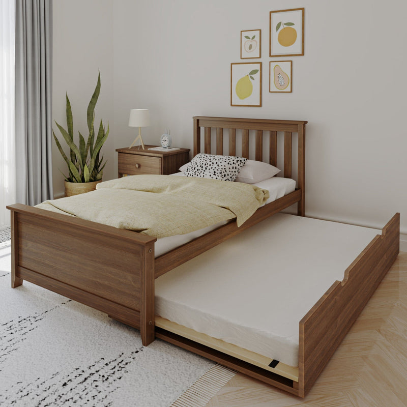 Space-saving wooden twin bed with pull-out trundle drawer, beige duvet and pillows, bedside table with lamp, potted plant and framed fruit wall art in a bright minimalist bedroom
