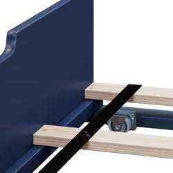 Close-up of blue bed frame slat system with light wood slats, black metal support strap and caster wheel for under-bed storage