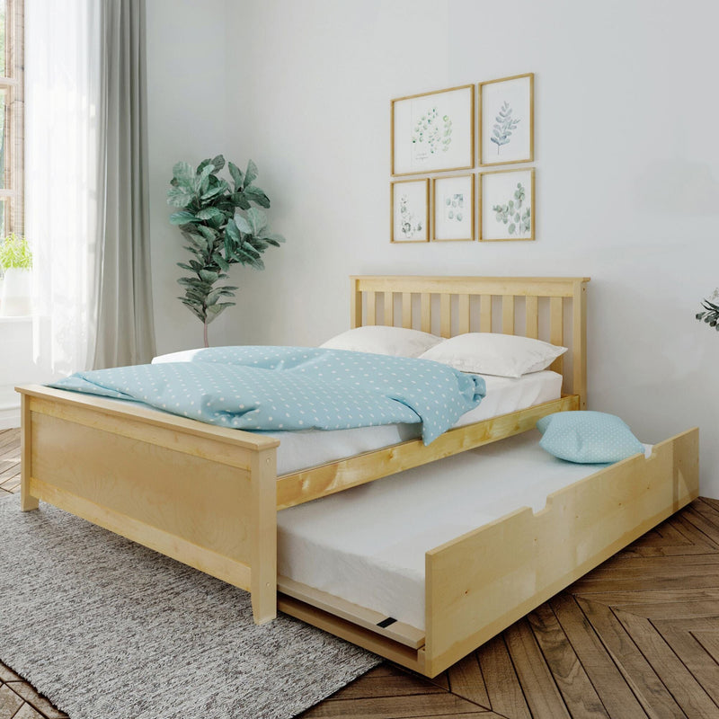 Scandinavian bedroom with light wood trundle bed, blue polka-dot duvet, botanical framed wall art, indoor plant and sheer curtains