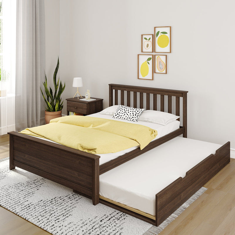 Modern dark wood trundle bed with yellow duvet and polka-dot pillow in a bright minimalist bedroom with wooden nightstand, potted plant, lamp, and framed fruit wall art