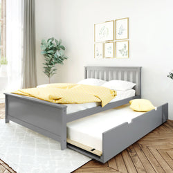 Gray wooden trundle bed with yellow polka-dot duvet and white pillows in bright modern bedroom with hardwood floors, area rug, potted plant and framed botanical wall art