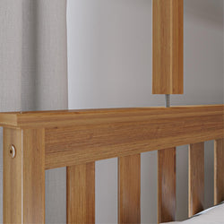 Close-up of natural oak slatted bed headboard with warm wood grain, modern minimalist bedroom furniture and neutral fabric backdrop