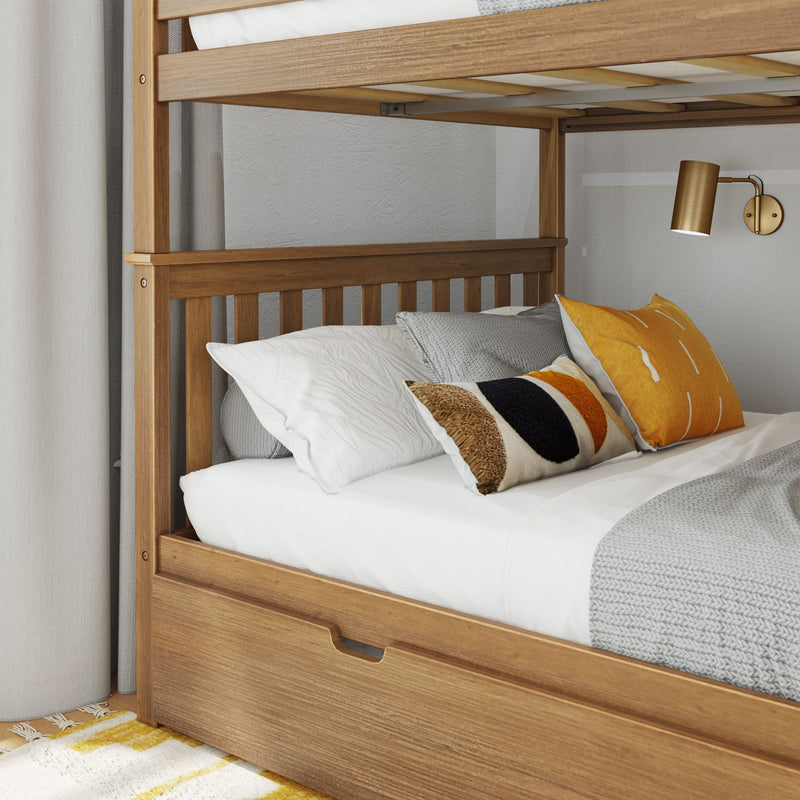 Wooden twin bunk bed with under-bed storage drawer, white and gray bedding, orange accent pillows and brass wall sconce