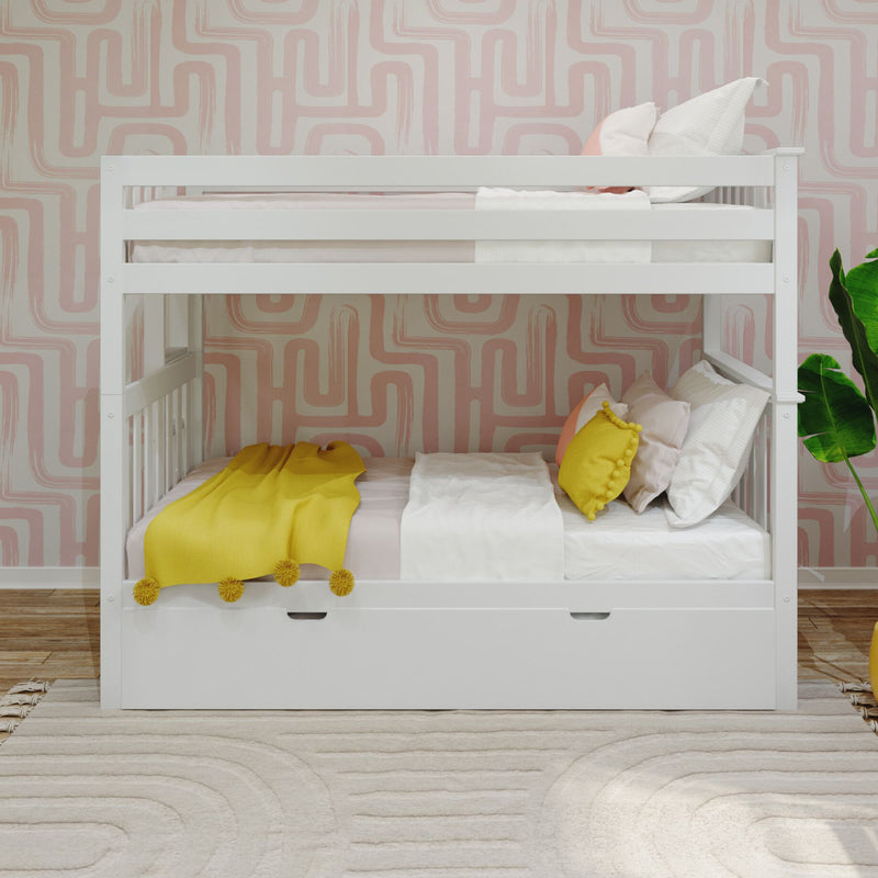Modern white wooden bunk bed with built-in lower storage drawer in a bright kids bedroom featuring pink geometric wallpaper, yellow throw blanket and accent pillows, light wood floor and potted plant