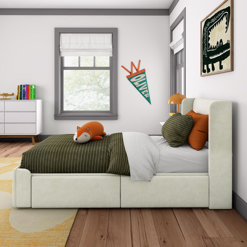 Modern kids bedroom interior with green striped bedding and sleeping fox plush, personalized "Oliver" pennant on wall, dinosaur framed art, white dresser and window with Roman shades