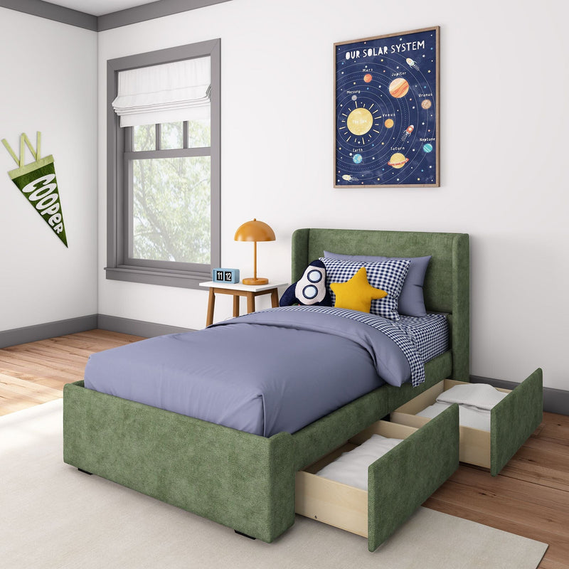 Cozy child’s bedroom with green bed featuring storage drawers, blue bedding, and decorative pillows, solar system wall art, and natural light from window.