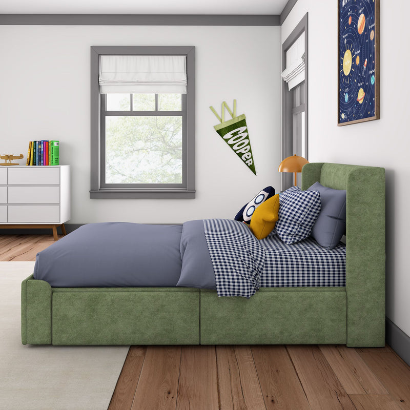 Modern children's bedroom with green upholstered bed, navy gingham bedding, rocket and planet wall art, white dresser with colorful books